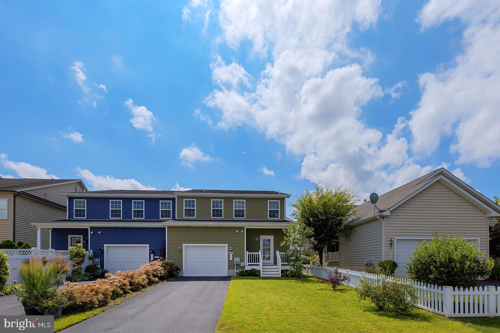 303 Brick Lane Milton, DE 19968 - Photo 5 of 71 a front view of a house with garden