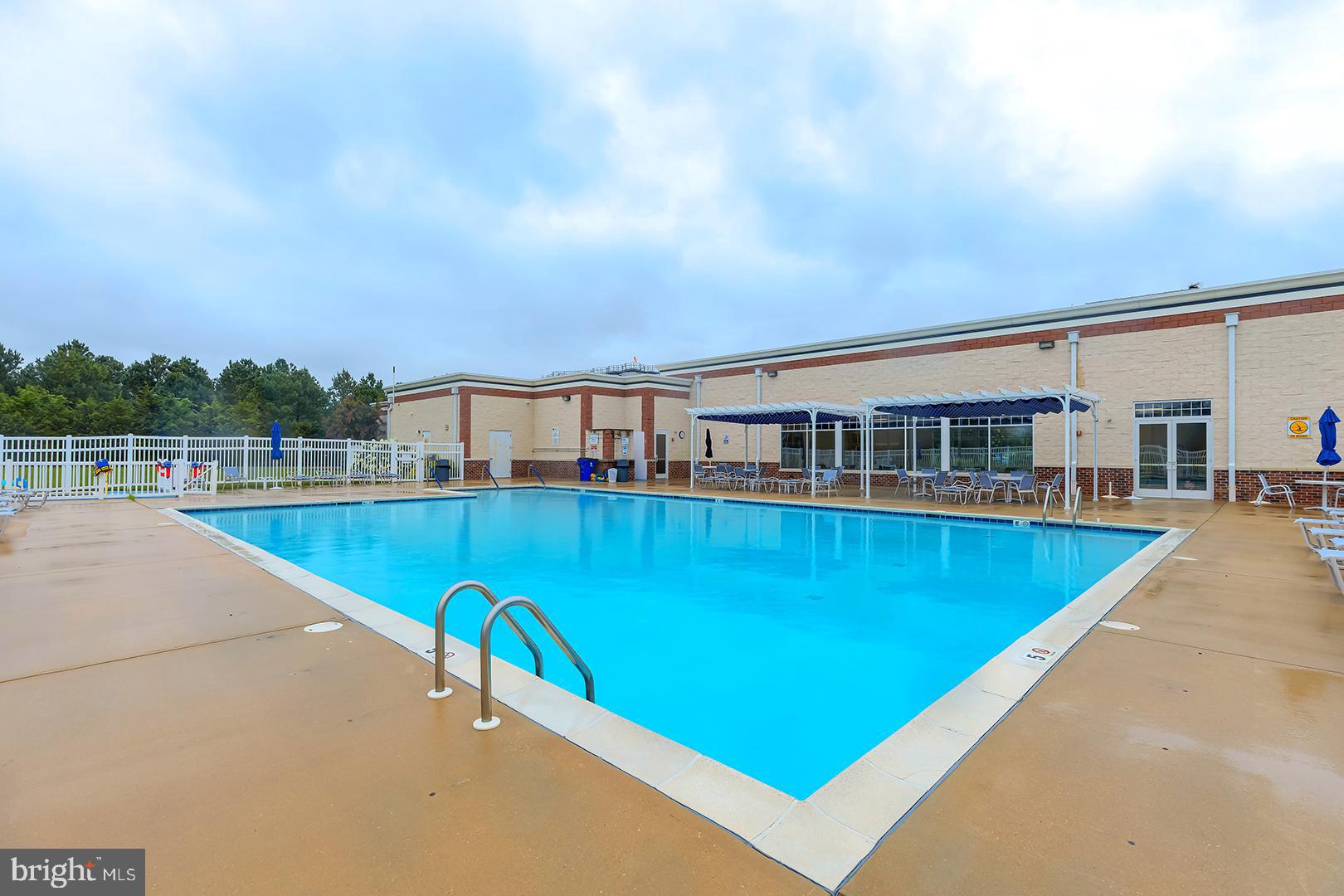 303 Brick Lane Milton, DE 19968 - Photo 56 of 71 a view of a swimming pool with a yard