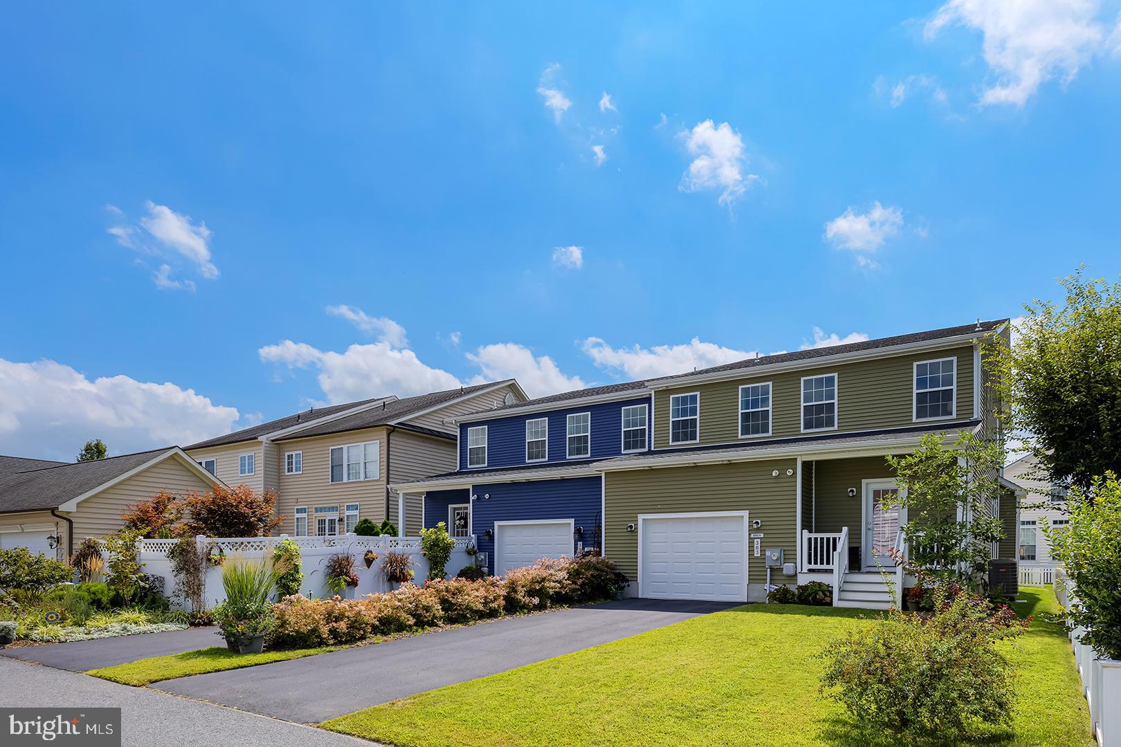 303 Brick Lane Milton, DE 19968 - Photo 8 of 71 a front view of a house with yard and swimming pool