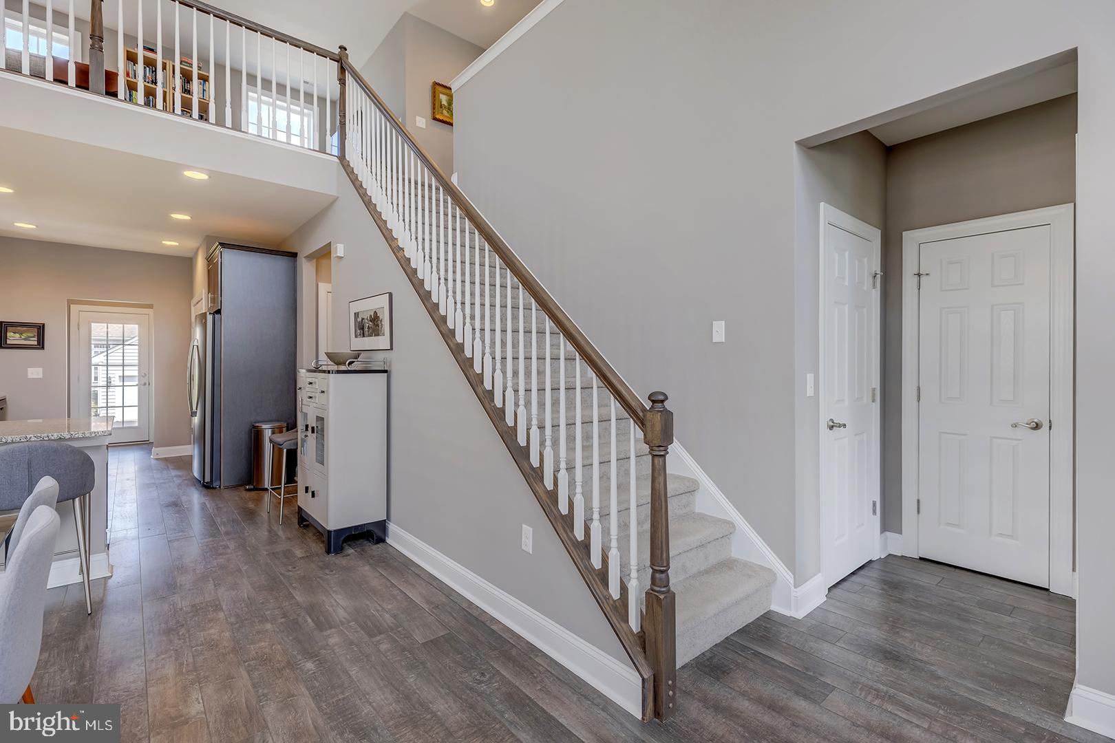 303 Brick Lane Milton, DE 19968 - Photo 10 of 71 a view of entryway and hall with wooden floor