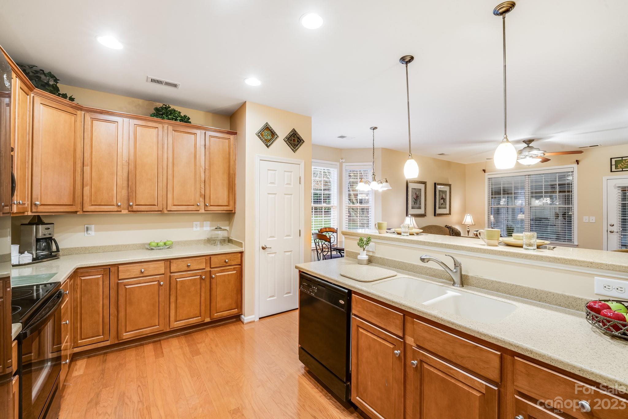 1037 Peridot Court Fort Mill, SC 29708 - Photo 8 of 33 a large kitchen with kitchen island a large counter top a sink a stove and a window