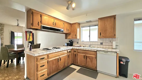 a kitchen with stainless steel appliances granite countertop a refrigerator a sink and dishwasher
