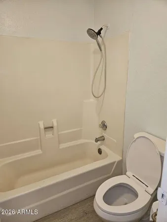 a bathroom with a toilet and a bath tub