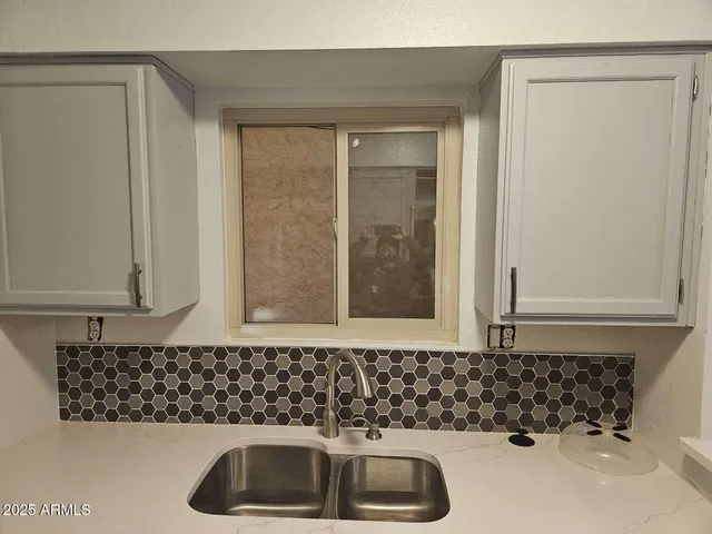 a bathroom with a sink and a window
