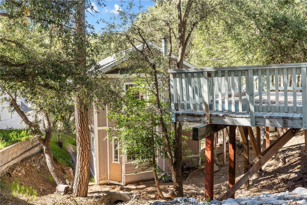 23561 Short Way Crestline, CA 92325 - Photo 18 of 18 a view of a roof with potted plants and large trees