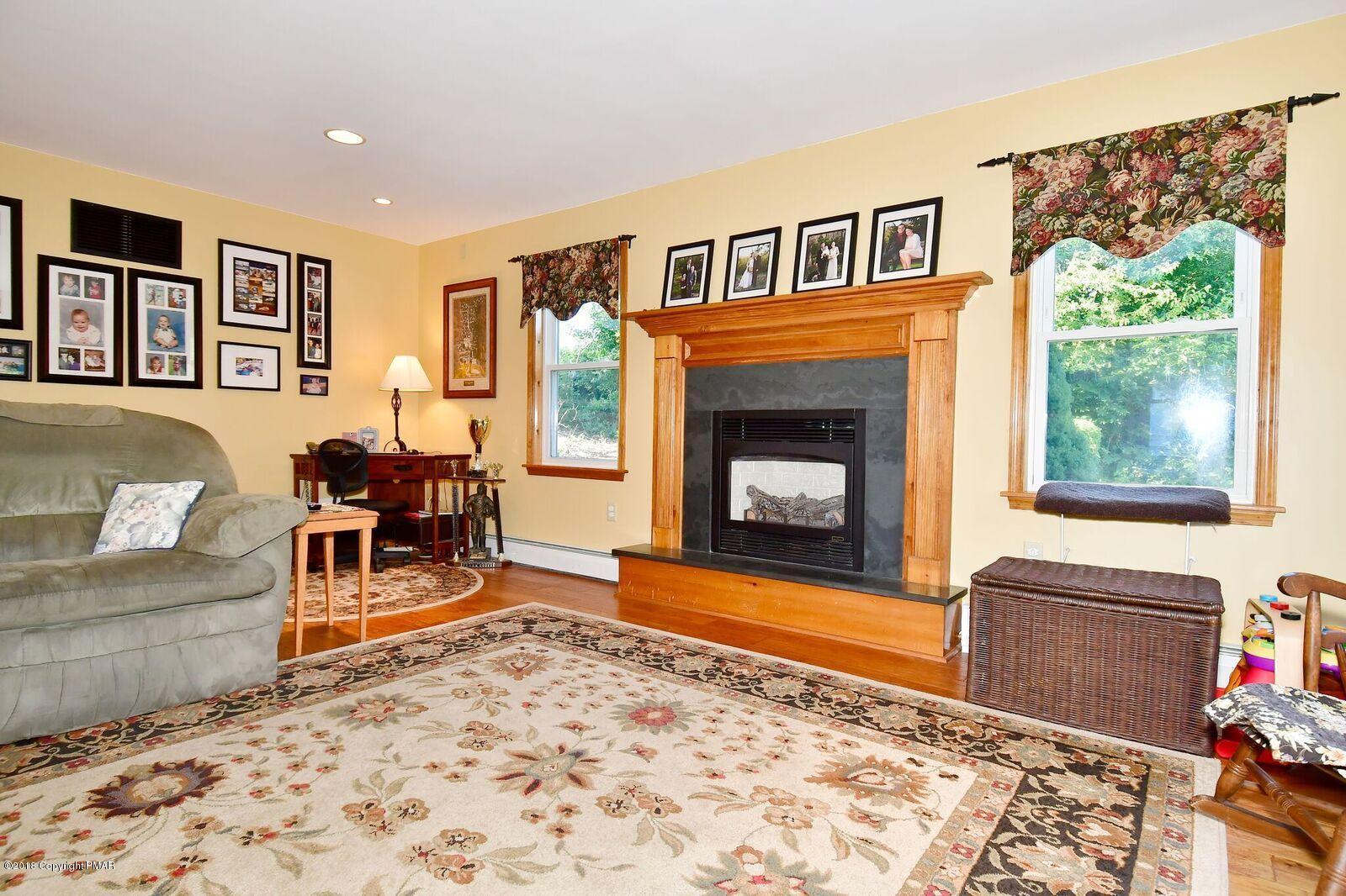 1185 Bangor Road Pen Argyl, PA 18072 - Photo 15 of 34 a living room with furniture and a fireplace