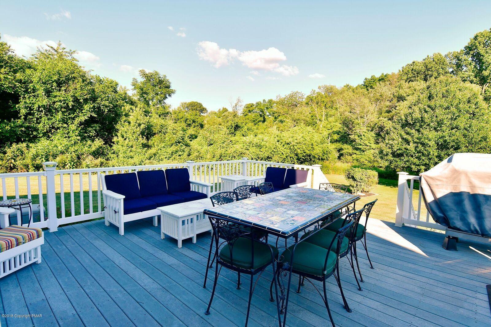 1185 Bangor Road Pen Argyl, PA 18072 - Photo 7 of 34 a view of a dining table and chairs on the deck