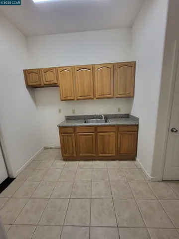 a kitchen with a stove top oven and cabinets