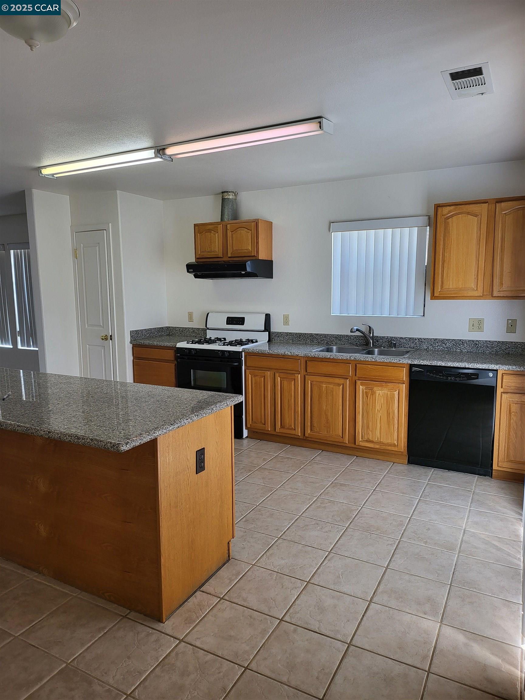 526 Harbour Way Richmond, CA 94801 - Photo 3 of 15 a kitchen with stainless steel appliances granite countertop a sink counter space cabinets and a window