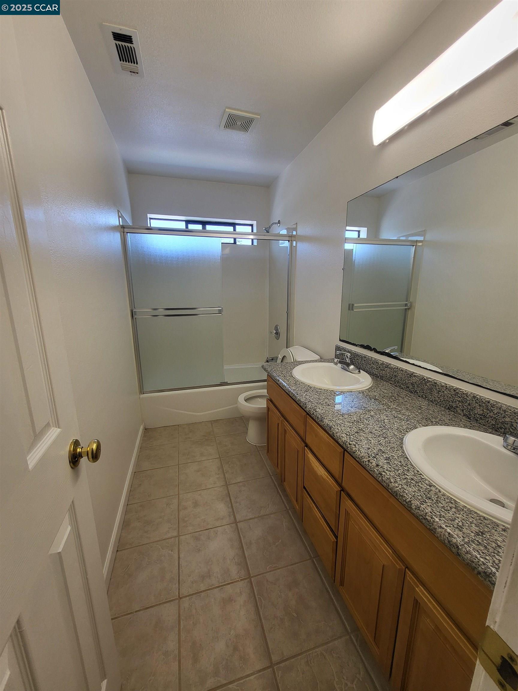 526 Harbour Way Richmond, CA 94801 - Photo 7 of 15 a bathroom with a granite countertop sink a toilet and a mirror