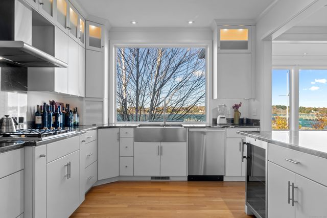 a kitchen with white cabinets and white appliances