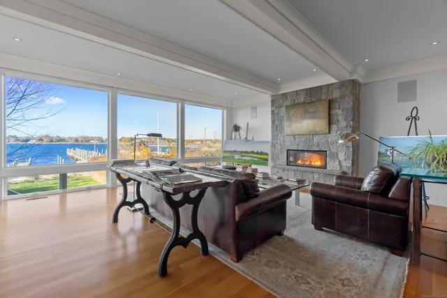 a view of a workspace with furniture and a floor to ceiling window