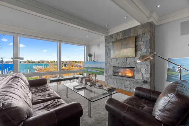 a living room with furniture and a floor to ceiling window