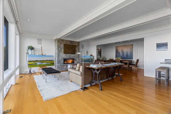 a living room with furniture a flat screen tv and a dining table