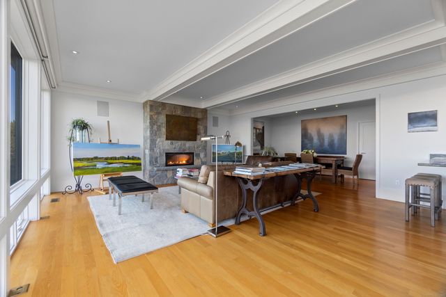 a living room with furniture a flat screen tv and a dining table