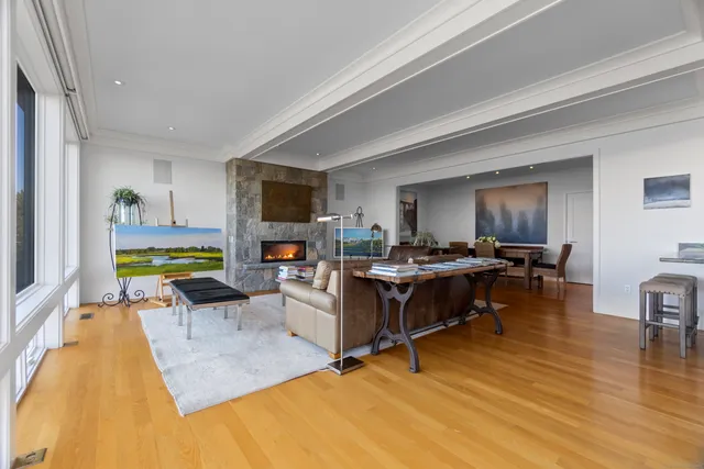 a living room with furniture a flat screen tv and a dining table
