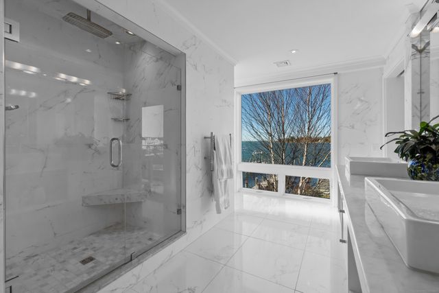 a bathroom with a tub shower and window