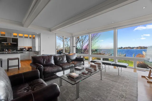 a living room with furniture and a floor to ceiling window