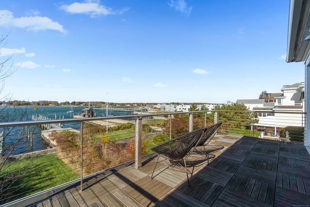 a view of a balcony with wooden floor and outdoor space