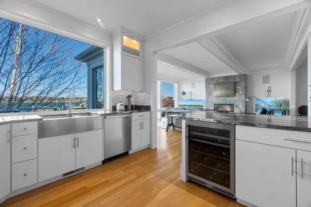 a living room with furniture kitchen view and a potted plant