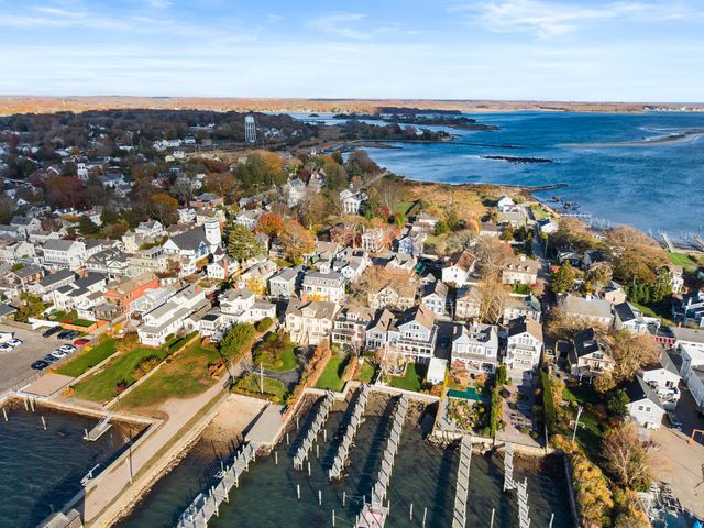 a kitchen with stainless steel appliances kitchen island granite countertop a stove a sink and white cabinets