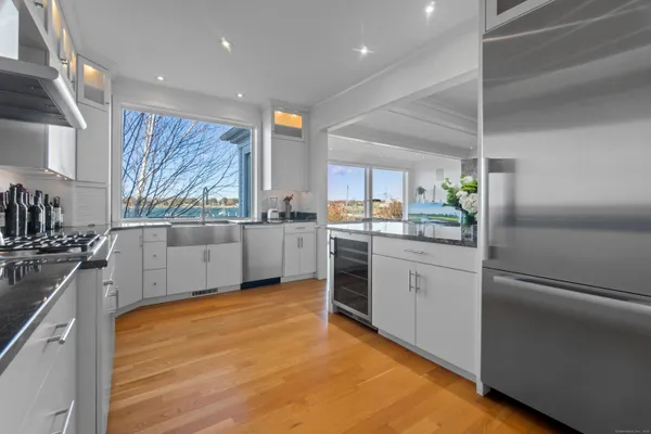a kitchen with white cabinets and white appliances