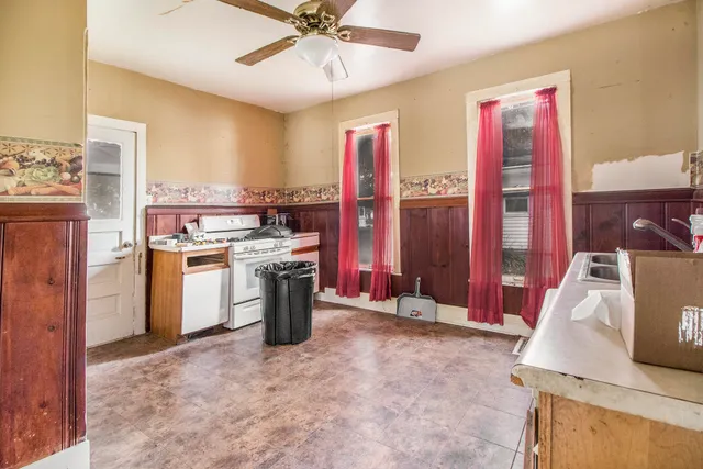 a view of a kitchen with fridge and wooden floor