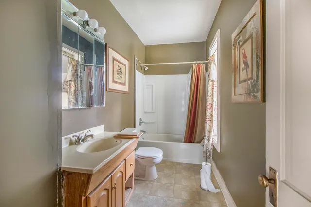 a spacious bathroom with a sink toilet and shower