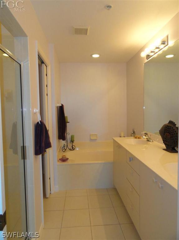 2060 Matecumbe Key Road, Unit 2702 Punta Gorda, FL 33955 - Photo 8 of 12 a bathroom with a tub sink and a mirror