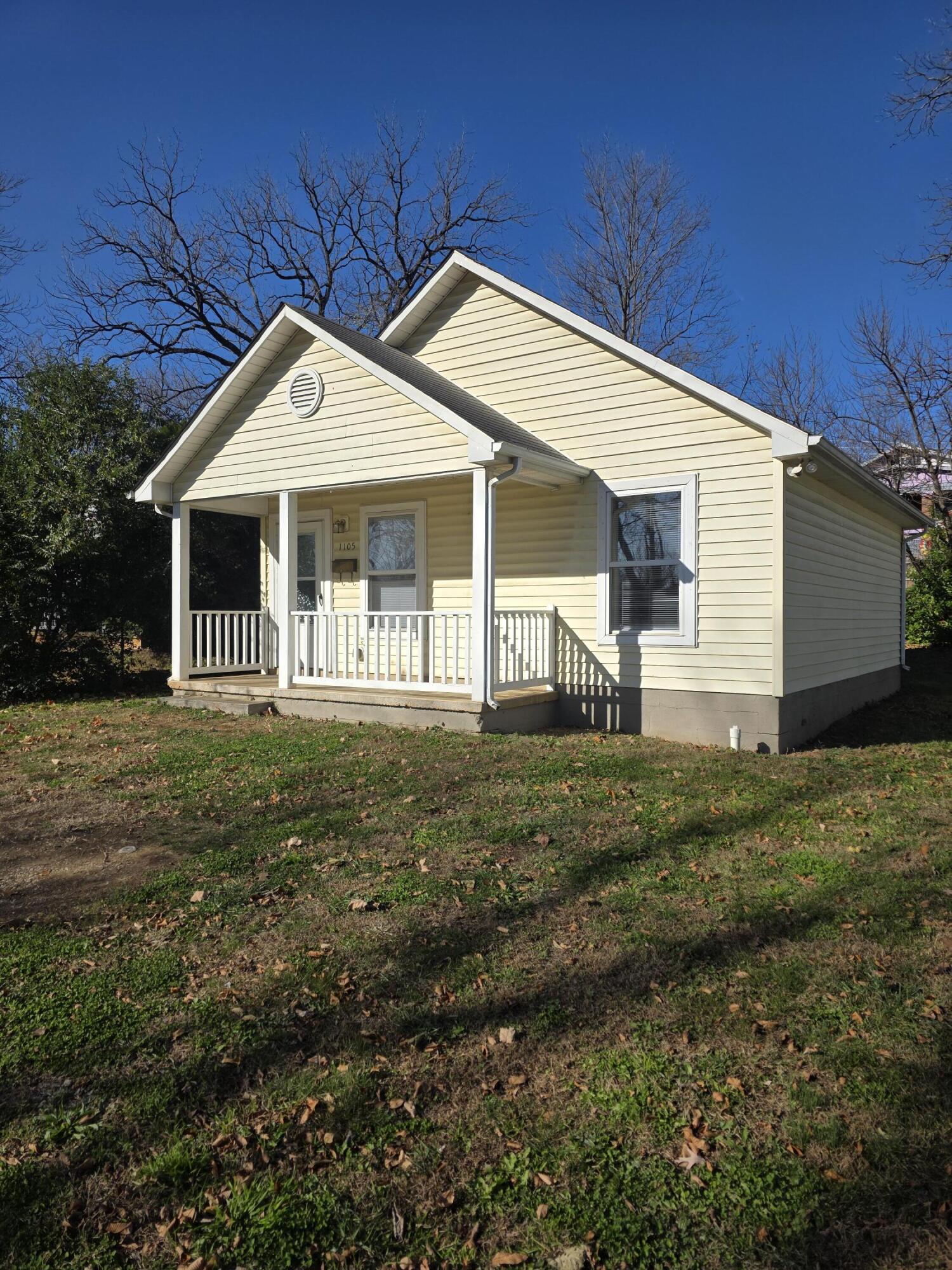 a front view of house with a garden