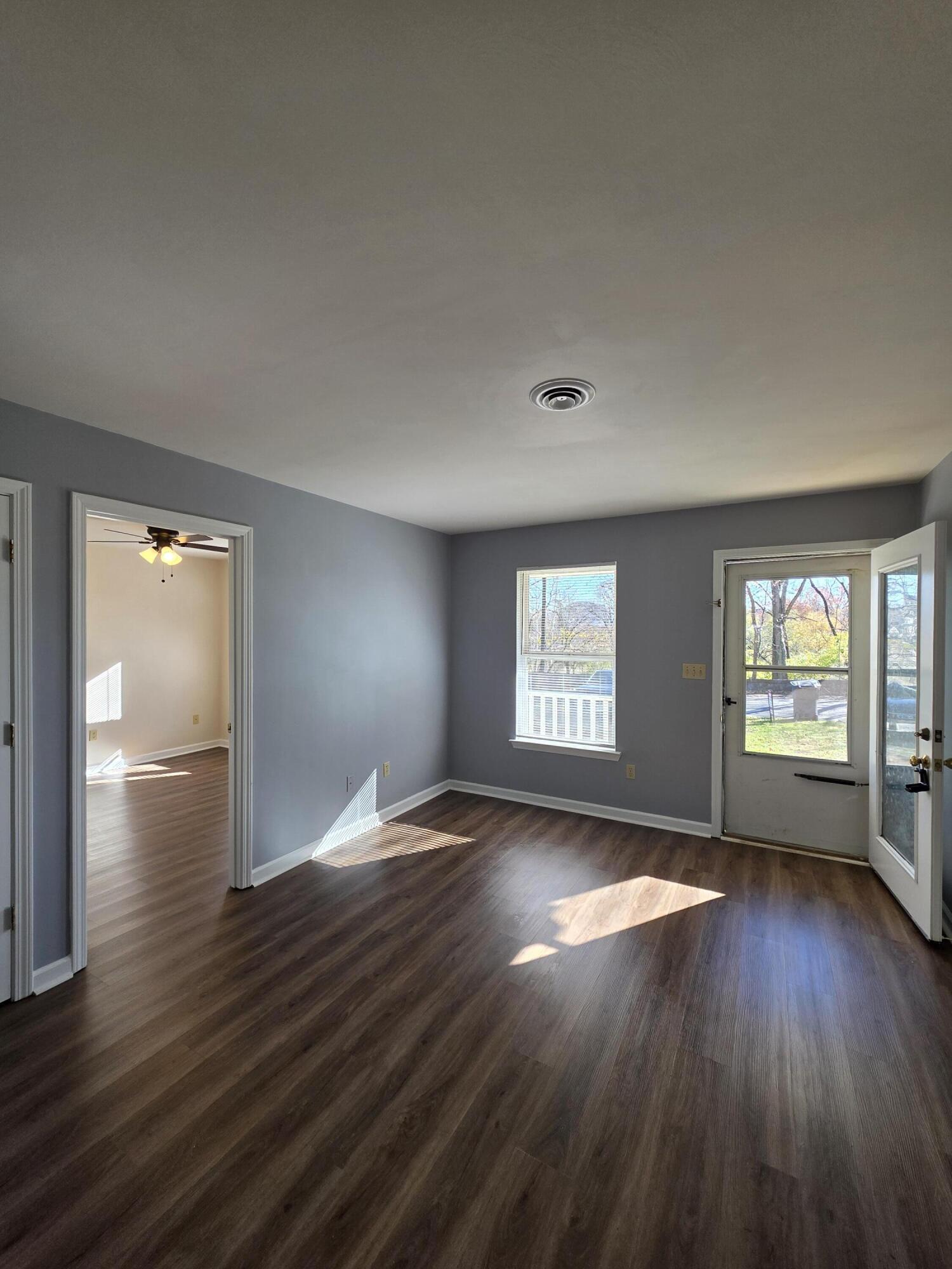 1105 Riverside Boulevard Southwest Roanoke, VA 24016 - Photo 3 of 11 an empty room with wooden floor and windows