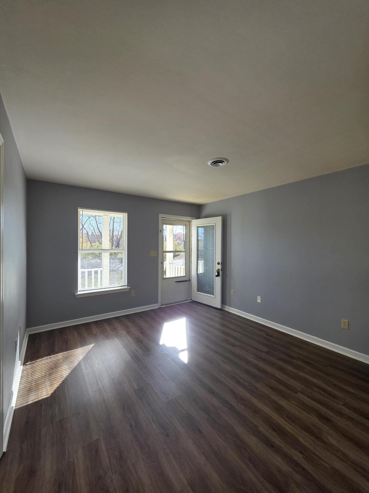 1105 Riverside Boulevard Southwest Roanoke, VA 24016 - Photo 4 of 11 an empty room with wooden floor and windows