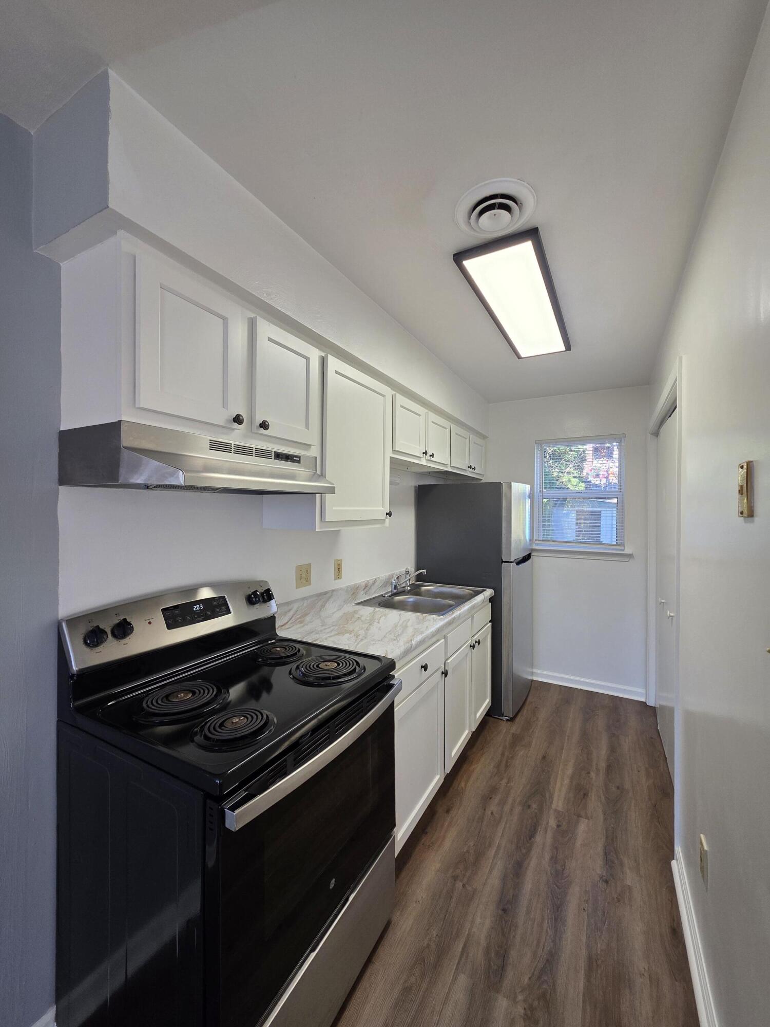 1105 Riverside Boulevard Southwest Roanoke, VA 24016 - Photo 7 of 11 a kitchen with stainless steel appliances a stove sink and microwave
