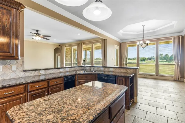 a large kitchen with kitchen island granite countertop a large window