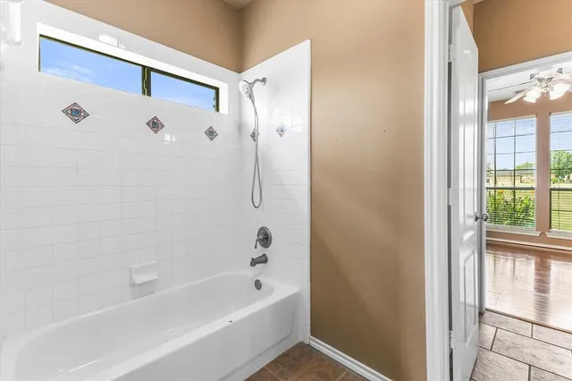 a bathroom with a bathtub and a shower