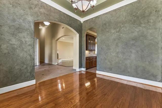 a view of a hallway with wooden floor and front door
