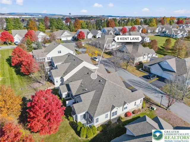 an aerial view of a houses with yard