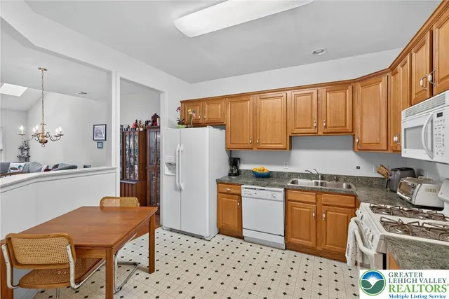 a kitchen with stainless steel appliances a stove a sink dishwasher and a refrigerator