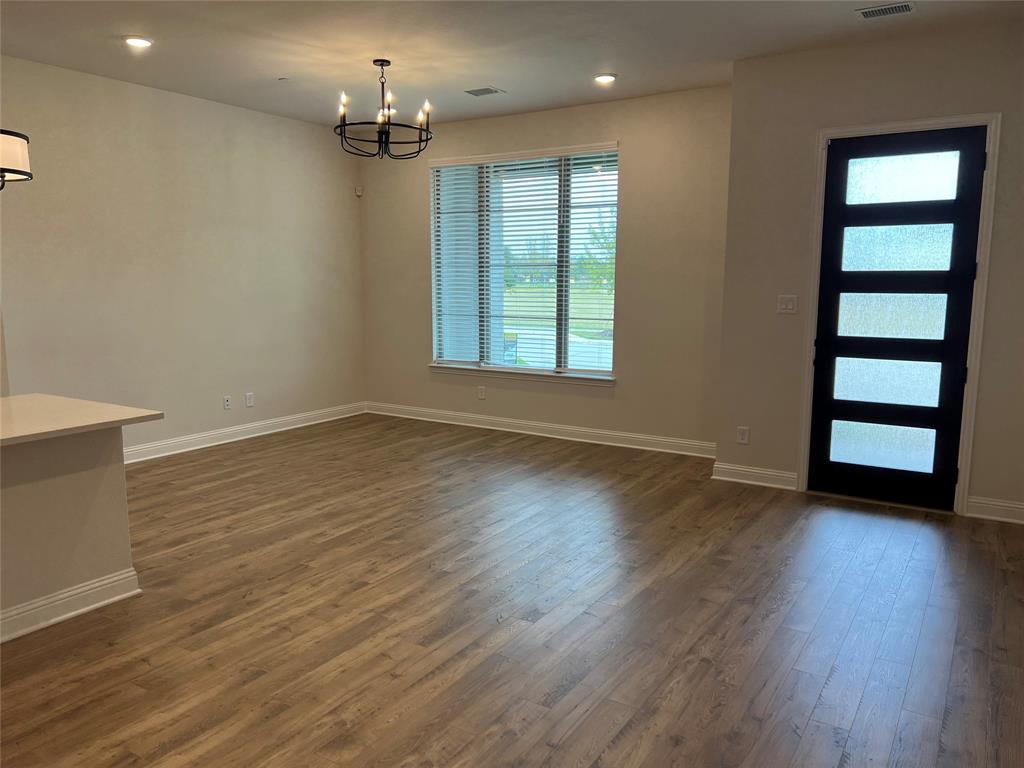 2522 Brunswick Way Allen, TX 75013 - Photo 6 of 19 wooden floor in an empty room with a window