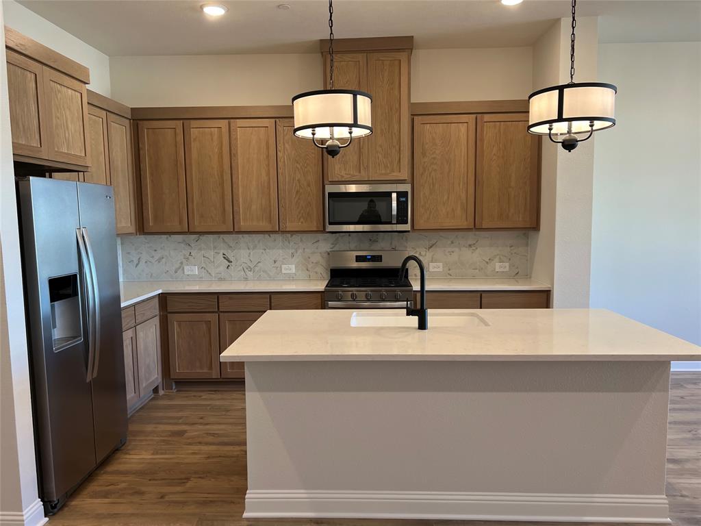 2522 Brunswick Way Allen, TX 75013 - Photo 7 of 19 a kitchen with a refrigerator and a sink