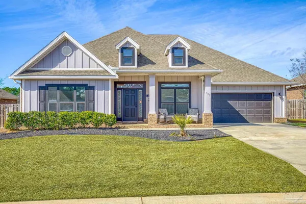 a front view of a house with a yard outdoor seating