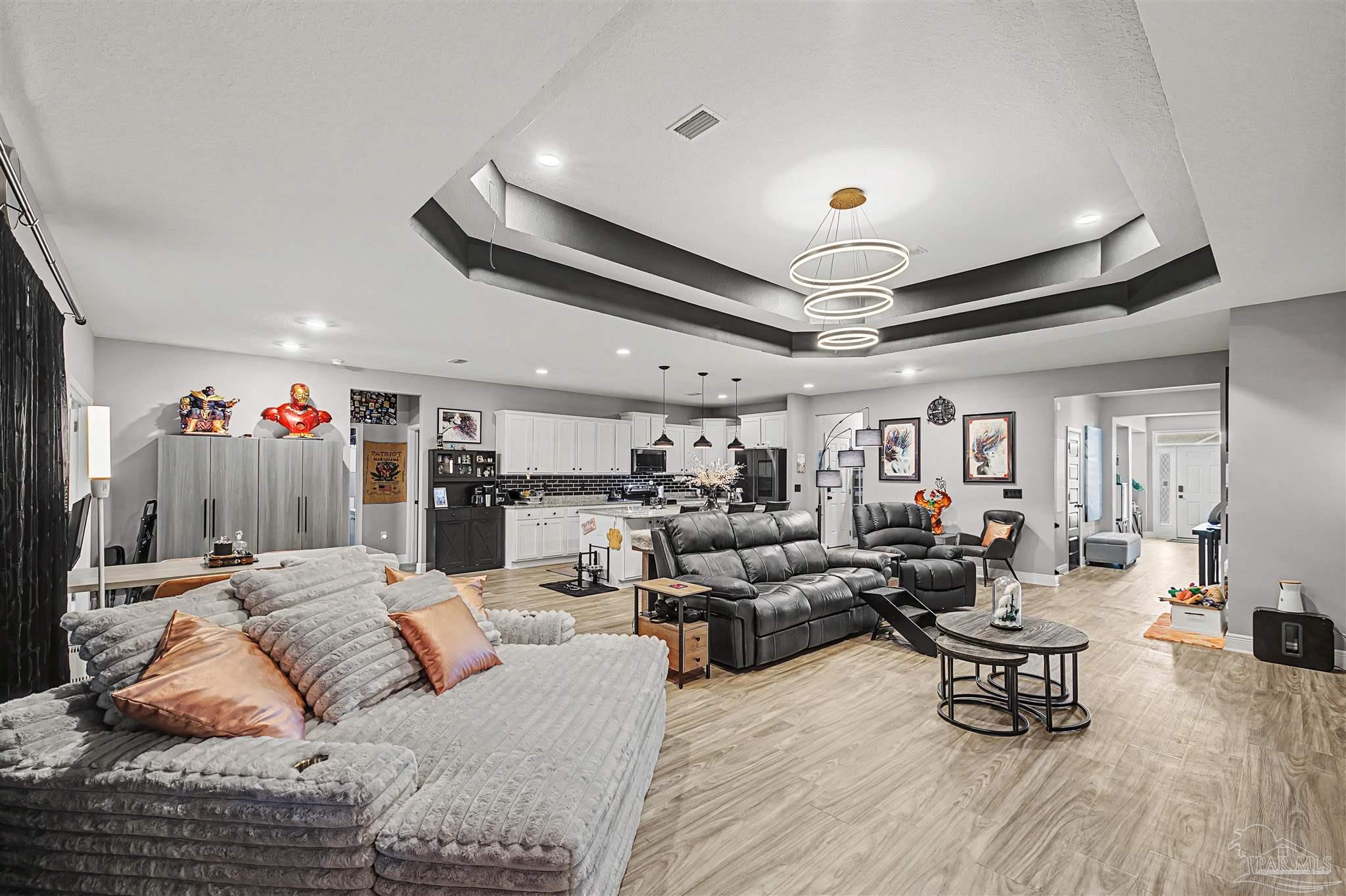 327 Cayden Way Cantonment, FL 32533 - Photo 15 of 64 a living room with furniture and a chandelier