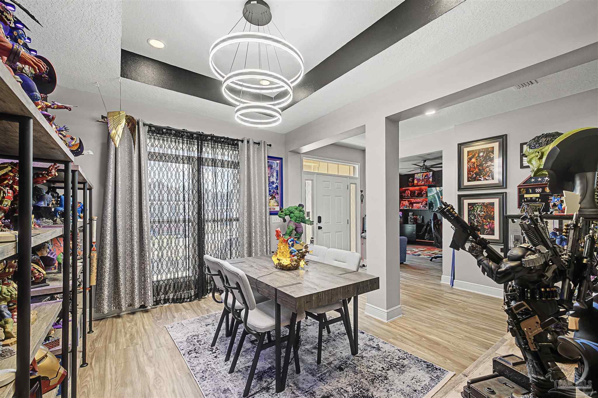 327 Cayden Way Cantonment, FL 32533 - Photo 2 of 64 a view of a dining room with furniture a chandelier and wooden floor