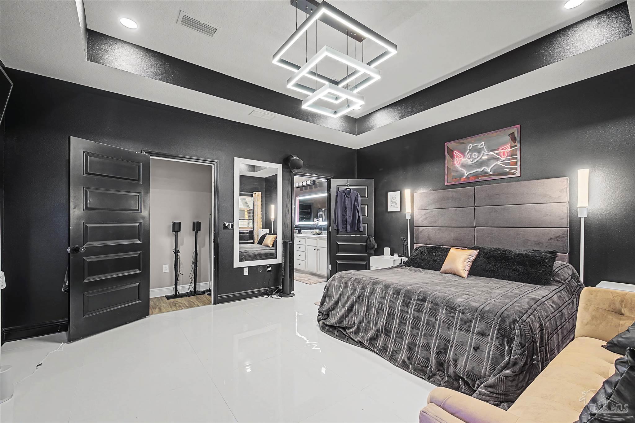 327 Cayden Way Cantonment, FL 32533 - Photo 23 of 64 a bedroom with a large bed and a walk in closet