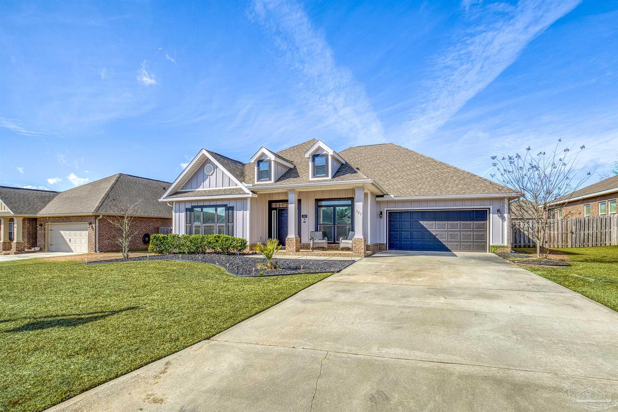 327 Cayden Way Cantonment, FL 32533 - Photo 40 of 64 a front view of a house with a garden