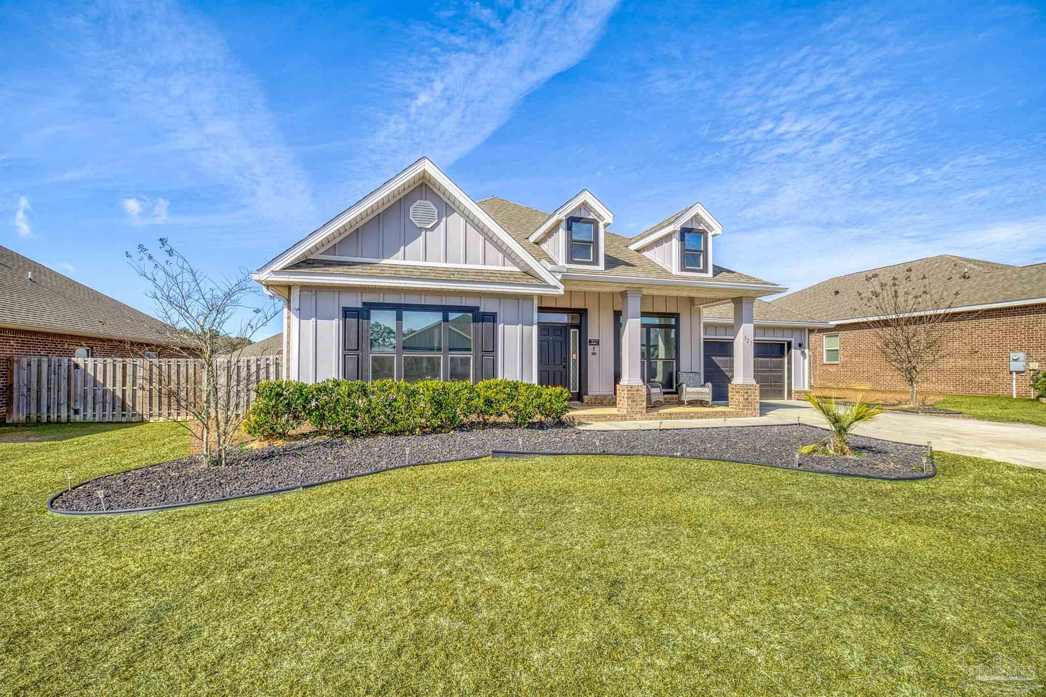 327 Cayden Way Cantonment, FL 32533 - Photo 43 of 64 a front view of a house with swimming pool having outdoor seating