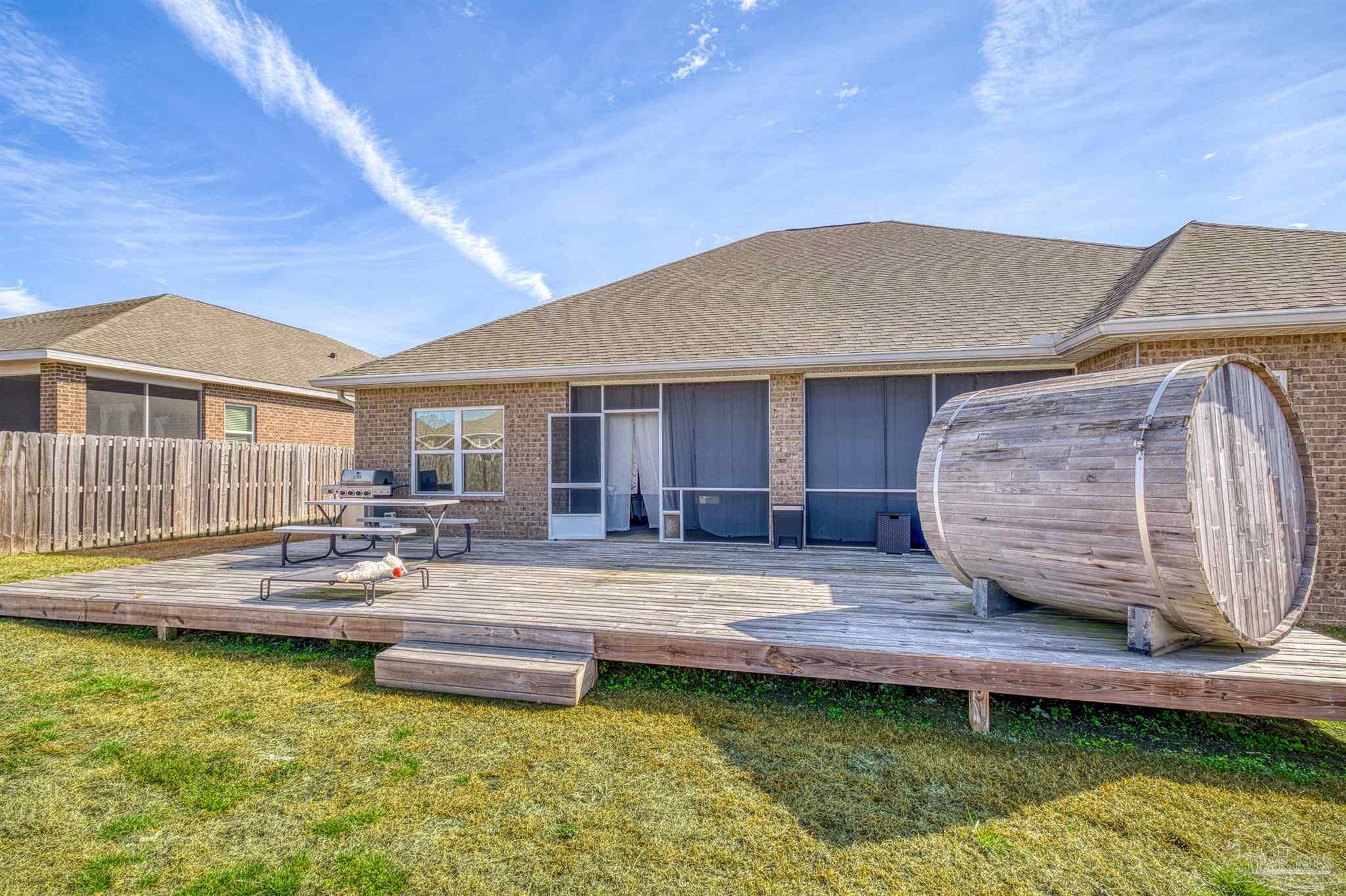 327 Cayden Way Cantonment, FL 32533 - Photo 55 of 64 a house view with swimming pool and wooden fence