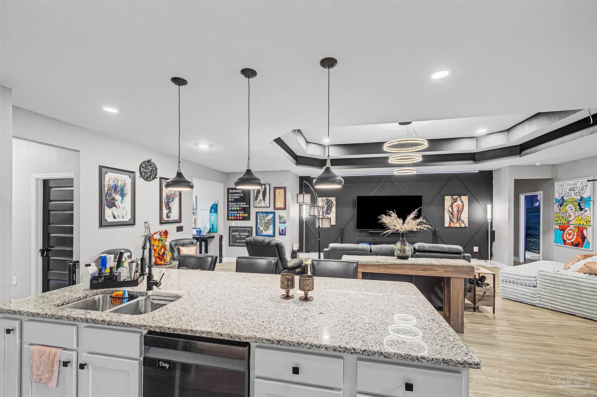 327 Cayden Way Cantonment, FL 32533 - Photo 8 of 64 a kitchen with stainless steel appliances granite countertop a sink a stove and a wooden floors