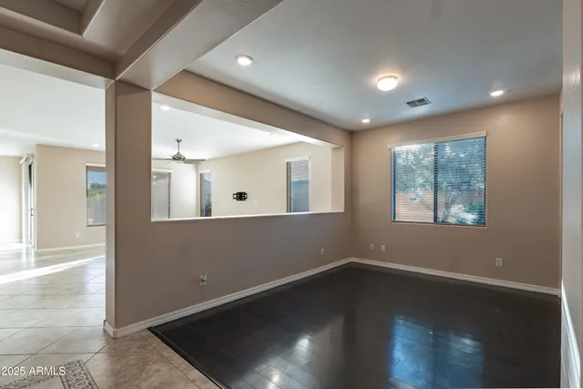 a view of a livingroom with wooden floor and a large window