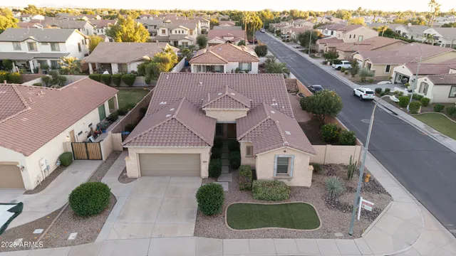 an aerial view of multiple houses with a yard